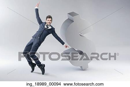 Happy man with huge dollar mark View Large Photo Image Picture - Happy man with huge dollar mark. Fotosearch