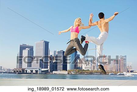 Stock Image - Joyful young couple training together. Fotosearch