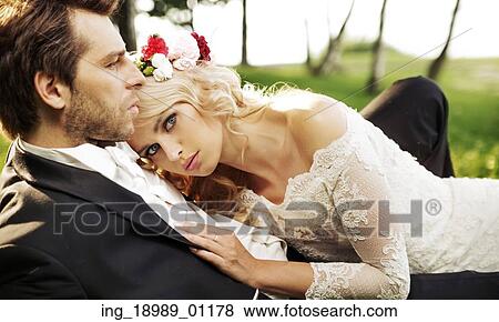 Stock Photo - Just married couple resting by the lake. Fotosearch