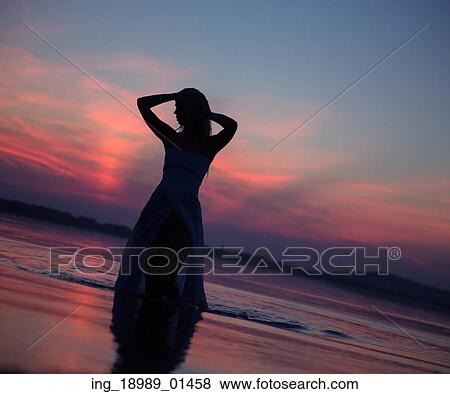 Stock Photo - Lady&rsquo; s silhouette in the river. Fotosearch