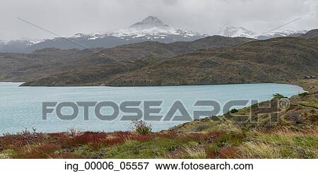 Stock Photo - Lake with mountain range in the background, Lake Pehoe, Torres Del Paine National Park, Patagonia, Chile. Fotosearch