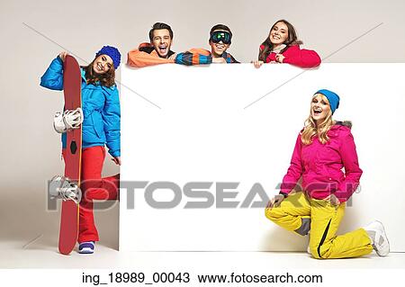 Stock Image - Lauhging people with the colorful winter equipment. Fotosearch