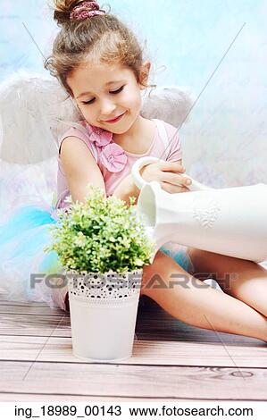 Stock Image - Little and cute girl with fancy wings. Fotosearch