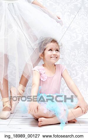 Stock Photo - Little andgirl next to the bal cute let dancer. Fotosearch