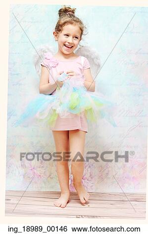Stock Photograph - Little cheerful child with white wings. Fotosearch