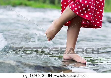 Picture - Little girl in the mountain brook. Fotosearch