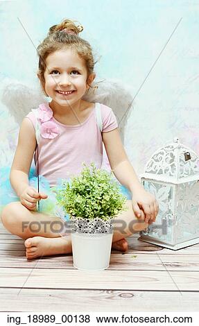 Little smiling witch with white wings View Large Photo Image Stock Photo - Little smiling witch with white wings. Fotosearch