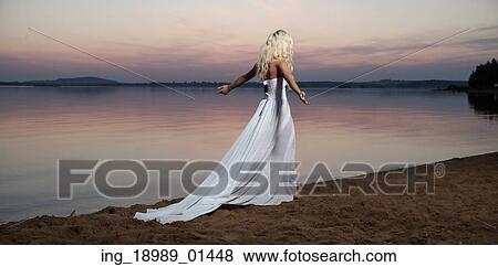 Lonely lady walking by the lakeside View Large Photo Image Stock Photo - Lonely lady walking by the lakeside. Fotosearch