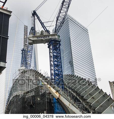 Stock Photo - Low angle view of a crane by modern skyscrapers, Manhattan, New York City, New York State, USA. Fotosearch