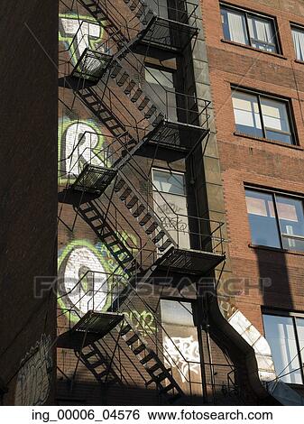 Stock Photograph - Low angle view of fire escape of a building at Golden Square Mile, Montreal, Quebec, Canada. Fotosearch