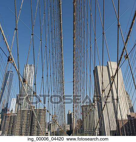 Stock Image - Low angle view of the Brooklyn Bridge with skylines, Manhattan, New York City, New York State, USA. Fotosearch
