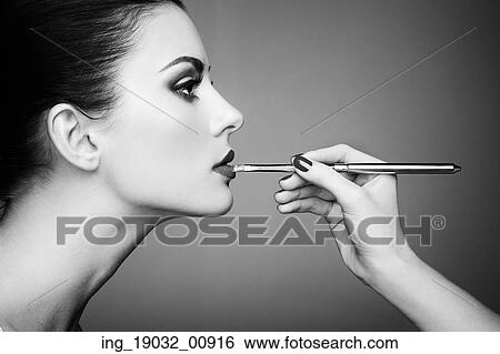 Makeup artist applies lipstick. Beautiful woman face. Perfect makeup. Black and white View Large Photo Image Stock Photograph - Makeup artist applies lipstick. Beautiful woman face. Perfect makeup. Black and white. Fotosearch