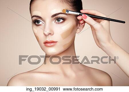 Makeup artist applies skintone. Beautiful woman face. Perfect makeup. Skincare foundation View Large Photo Image Stock Image - Makeup artist applies skintone. Beautiful woman face. Perfect makeup. Skincare foundation. Fotosearch