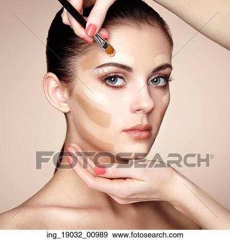Makeup artist applies skintone. Beautiful woman face. Perfect makeup. Skincare foundation View Large Photo Image Stock Photo - Makeup artist applies skintone. Beautiful woman face. Perfect makeup. Skincare foundation. Fotosearch