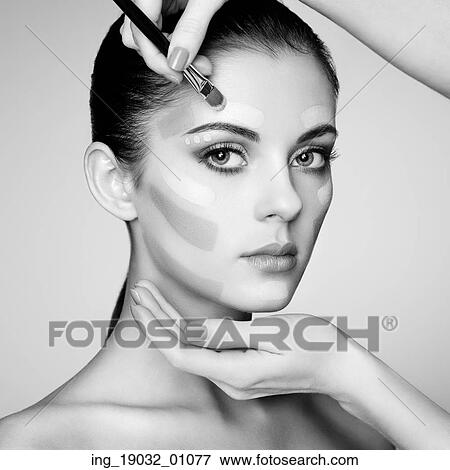 Makeup artist applies skintone. Beautiful woman face. Perfect makeup. Skincare foundation. Black and white View Large Photo Image Stock Photo - Makeup artist applies skintone. Beautiful woman face. Perfect makeup. Skincare foundation. Black and white. Fotosearch