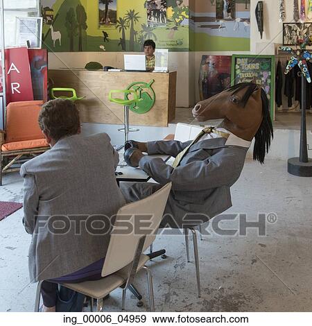 Stock Photo - Man sitting with a person wearing a horse costume, Santiago, Santiago Metropolitan Region, Chile. Fotosearch