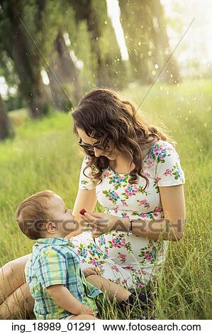 Mom feeding her little son with strawberry View Large Photo Image Stock Image - Mom feeding her little son with strawberry. Fotosearch
