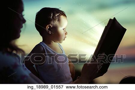 Stock Photo - Mom reading for her little son. Fotosearch