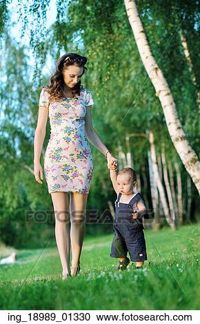 Stock Image - Mom walking with her cute little son. Fotosearch