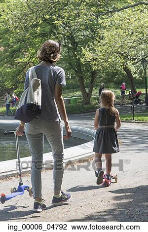 Mother and daughter with push scooter in Central Park, Manhattan, New York City, New York State, USA View Large Photo Image Stock Image - Mother and daughter with push scooter in Central Park, Manhattan, New York City, New York State, USA. Fotosearch