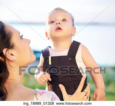 Stock Photo - Mother carrying her thoughtful child. Fotosearch