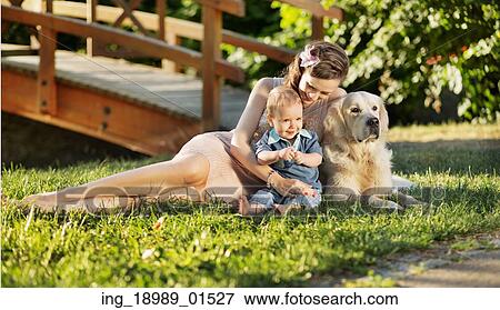 Stock Photo - Mother hugging son and dog. Fotosearch