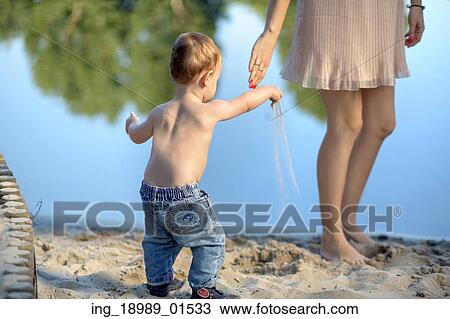 Mother playing with her lovely child View Large Photo Image Stock Image - Mother playing with her lovely child. Fotosearch