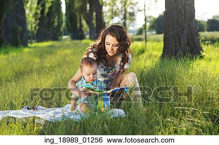 Stock Photograph - Mother reading fairy tales for the son. Fotosearch