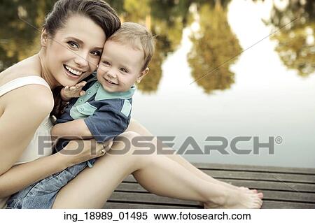Stock Photography - Mother with child looking at the camera. Fotosearch