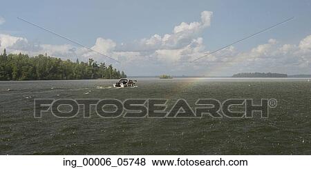 Stock Photo - Motorboat in a lake, Lake of the Woods, Ontario, Canada. Fotosearch