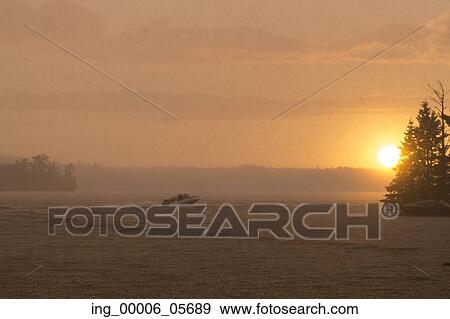 Stock Photo - Motorboat on the lake, Lake of the Woods, Ontario, Canada. Fotosearch