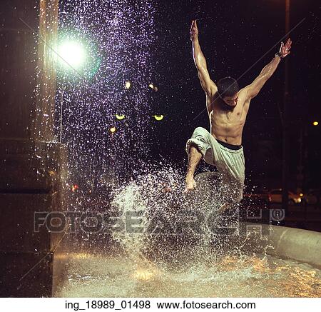 Muscular guy jumping in fountain View Large Photo Image Stock Photo - Muscular guy jumping in fountain. Fotosearch