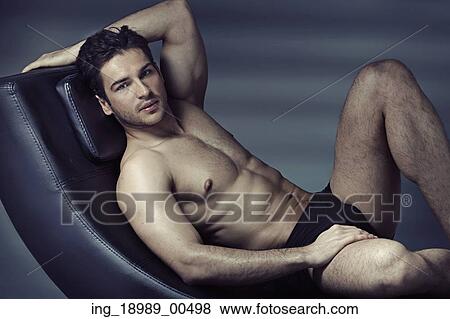 Stock Photo - Muscular man relaxing after hard training. Fotosearch