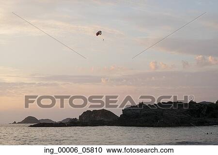Parasailing at sunset, Zihuatanejo, Guerrero, Mexico View Large Photo Image Stock Image - Parasailing at sunset, Zihuatanejo, Guerrero, Mexico. Fotosearch