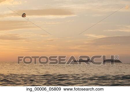 Parasailing at sunset, Zihuatanejo, Guerrero, Mexico View Large Photo Image Stock Photo - Parasailing at sunset, Zihuatanejo, Guerrero, Mexico. Fotosearch