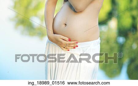 Stock Photograph - Photo presenting the belly of pregnant woman. Fotosearch