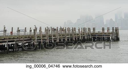 Stock Photograph - Pier at Upper New York Bay, Liberty Island, New York Harbor, Manhattan, New York City, New York State, USA. Fotosearch