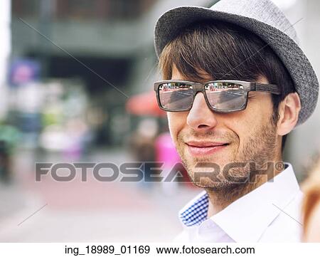 Stock Photo - Portrait of a handsome young guy with sunglasses. Fotosearch