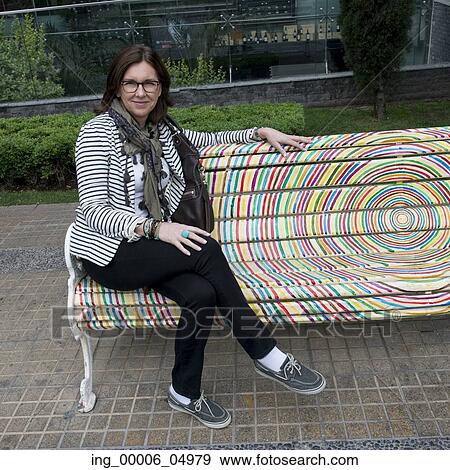 Portrait of a happy woman sitting on bench, Santiago, Santiago Metropolitan Region, Chile View Large Photo Image Stock Photo - Portrait of a happy woman sitting on bench, Santiago, Santiago Metropolitan Region, Chile. Fotosearch