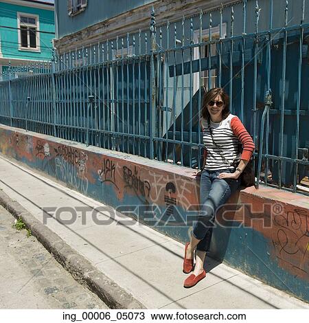 Portrait of a woman leaning against a fence, Valparaiso, Chile View Large Photo Image Stock Image - Portrait of a woman leaning against a fence, Valparaiso, Chile. Fotosearch