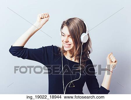portrait of a young woman listening to music with headphones View Large Photo Image Picture - portrait of a young woman listening to music with headphones. Fotosearch