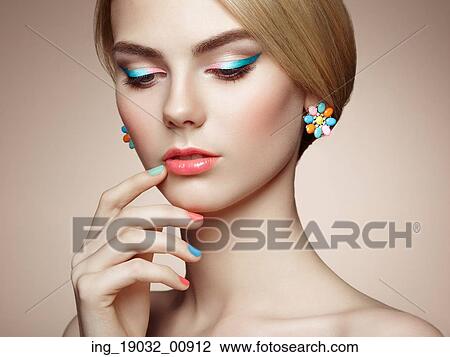 Stock Image - Portrait of beautiful sensual woman with elegant hairstyle. Perfect makeup. Blonde girl. Fashion photo. Jewelry. Fotosearch