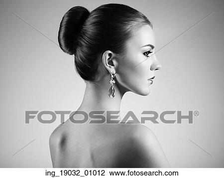Stock Image - Portrait of beautiful sensual woman with elegant hairstyle. Perfect makeup. Brunette girl. Fashion photo. Fotosearch