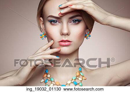 Stock Image - Portrait of beautiful sensual woman with elegant hairstyle. Perfect makeup. Blonde girl. Fashion photo. Jewelry. Fotosearch