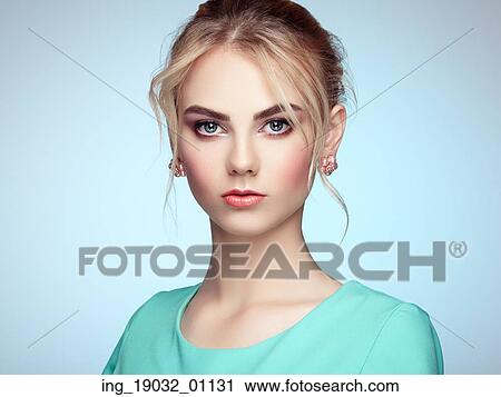 Stock Image - Portrait of beautiful sensual woman with elegant hairstyle. Perfect makeup. Blonde girl. Fashion photo. Fotosearch