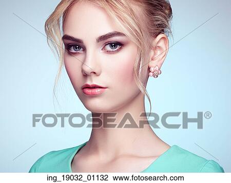 Stock Image - Portrait of beautiful sensual woman with elegant hairstyle. Perfect makeup. Blonde girl. Fashion photo. Fotosearch