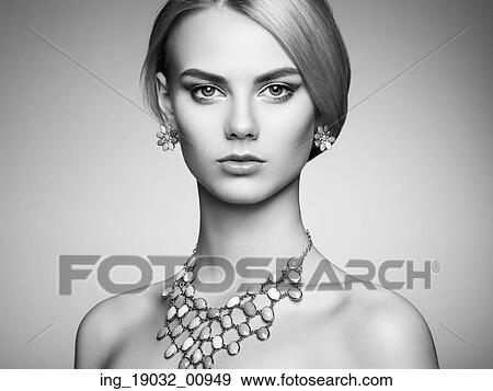 Stock Photo - Portrait of beautiful sensual woman with elegant hairstyle. Perfect makeup. Blonde girl. Fashion photo. Jewelry. Black and white. Fotosearch