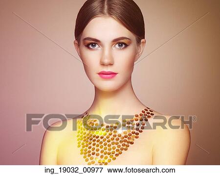 Stock Photo - Portrait of beautiful sensual woman with elegant hairstyle. Perfect makeup. Blonde girl. Fashion photo. Jewelry. Fotosearch