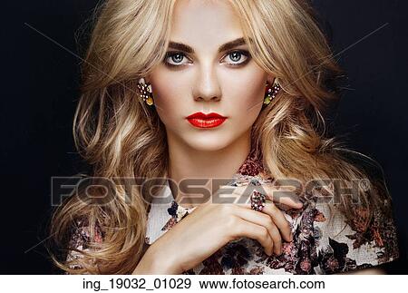 Stock Photo - Portrait of beautiful sensual woman with elegant hairstyle. Perfect makeup. Blonde girl. Fashion photo. Jewelry and dress. Fotosearch