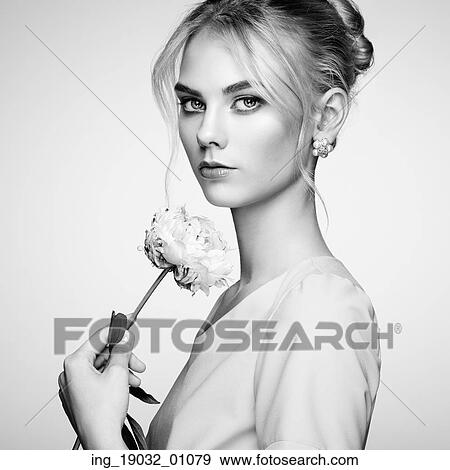 Stock Photo - Portrait of beautiful sensual woman with elegant hairstyle. Perfect makeup. Blonde girl. Fashion photo. Flowers. Black and white. Fotosearch